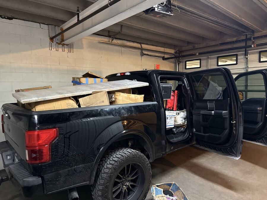 Pickup truck loaded with boxes inside a commercial garage