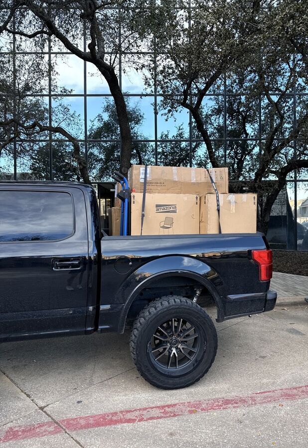 Truck bed with boxed furniture strapped in for delivery